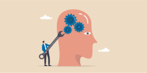 Person holding a tool to tighten the gears in someone's mind.